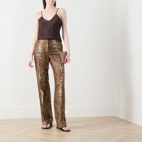 Model wearing Max Mara Studio Comma Cami Top in chocolate, styled with gold leopard-print sequin flared trousers and strappy heeled sandals.