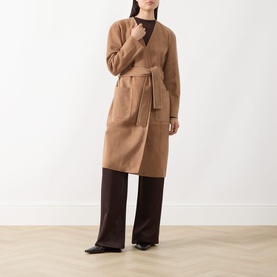 Model wearing Max Mara Studio camel lamb leather trench coat with belt and patch pockets, styled with dark trousers and black top.