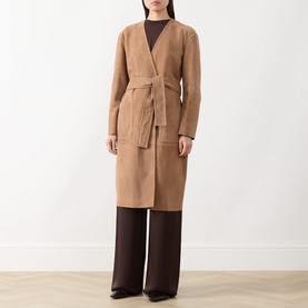 Model wearing Max Mara Studio camel lamb leather belted coat with V-neckline, styled with dark brown wide-leg trousers.