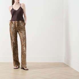 Model wearing Max Mara Studio Romana Leopard Straight Leg Trousers in brown spotted silk-twill, styled with a dark cami top and flat sandals.