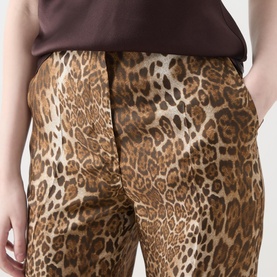 Model wearing Max Mara Studio Romana Leopard Straight Leg Trousers in brown spotted silk-twill, styled with a brown top