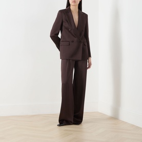 Model wearing Max Mara Studio Chocolate wide-leg trousers, styled with a matching double-breasted blazer in chocolate brown.