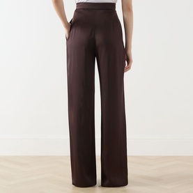 Model wearing Max Mara Studio Chocolate wide-leg high-waist trousers in acetate-viscose blend, styled with a white top.