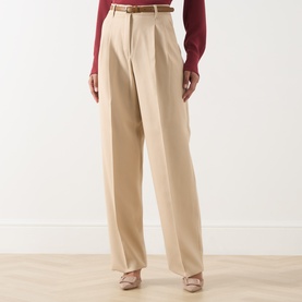 Model wearing Max Mara Studio Adunco Wide Leg Trousers in beige with pressed creases and included belt, styled with a burgundy top and nude heels.