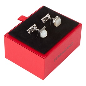 Salvatore Ferragamo silver cufflinks with white stone inlay, presented in a red branded gift box with black velvet lining.