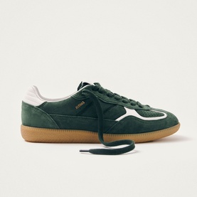 Alohas green suede trainer with white leather panel, gold branding, flat laces, and gum rubber sole, side profile view.
