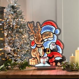 Festive Productions Infinity Santa and Reindeer 40cm LED light decoration in multi colours, styled with Christmas tree and candles