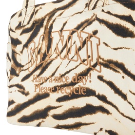 Ganni Zebra Logo XXL Shopper Tote Bag in Egret, close-up of embroidered logo and zebra print canvas with "have a nice day" text