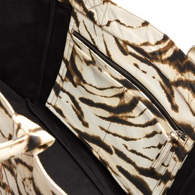 Ganni Zebra Logo XXL Shopper Tote Bag in Egret, close-up of zebra print canvas exterior with silver zip pocket detail