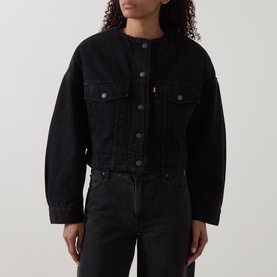 Model wearing Levis Cropped Sherpa Trucker Jacket in Slight Night black denim, collarless, dropped shoulders, front button fastening, styled with