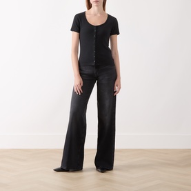 Model wearing Levis anthracite night cotton T-shirt with button placket, styled with wide-leg black jeans and black pointed heels.