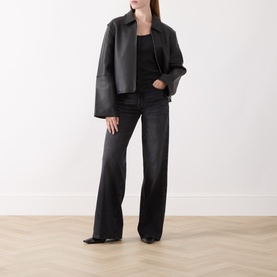 Model wearing Levi's Anthracite Night T-shirt, styled with black wide-leg jeans and an oversized dark leather jacket.