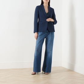 Model wearing Max Mara Weekend navy virgin wool blazer, styled with wide-leg blue jeans and black heeled sandals.