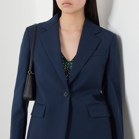 Model wearing Max Mara Weekend navy virgin wool blazer, styled with green sequin top and black shoulder bag.