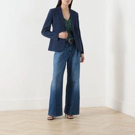 Model wearing Max Mara Weekend navy wool blazer, styled with green top, wide-leg jeans and strappy heels.