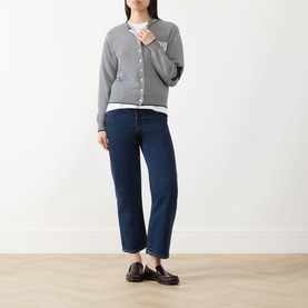 Model wearing Max Mara Weekend Teiera Stripe Cardigan in Navy Pinstripes with white tee, dark blue straight-leg jeans and black loafers