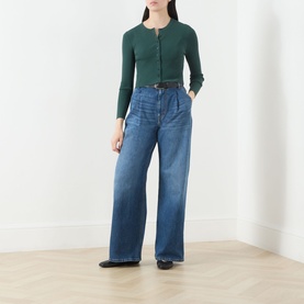Model wearing Max Mara Weekend Tennis Ribbed Cropped Cardigan in green, styled with wide-leg blue jeans and a black belt.