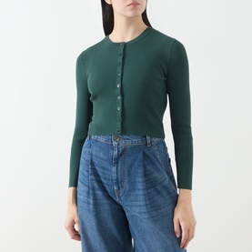 Model wearing Max Mara Weekend Tennis Ribbed Cropped Cardigan in green with round neck and front buttons, styled with blue wide-leg jeans.