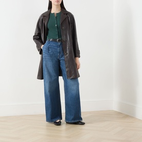 Model wearing Max Mara Weekend Tennis Ribbed Cropped Cardigan in green, styled with dark brown leather coat and wide-leg blue jeans.