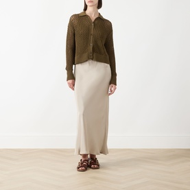 Model wearing Max Mara Main Film Open-Knit Cardigan in kaki, polo collar, button front, styled with beige maxi skirt and brown sandals
