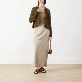 Model wearing Max Mara Main Film Open-Knit Cardigan in khaki over a vest top, styled with a cream maxi skirt, brown sandals and small bag.