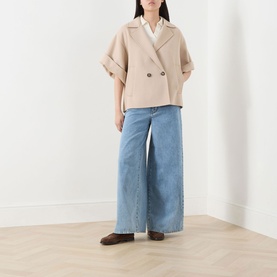 Model wearing Max Mara Weekend Neo Double-Breasted Peacoat in sand wool, styled with wide-leg blue jeans and dark loafers.