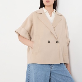 Model wearing Max Mara Weekend Neo Double-Breasted Peacoat in sand, short sleeves, notched lapels, styled with blue jeans and white shirt