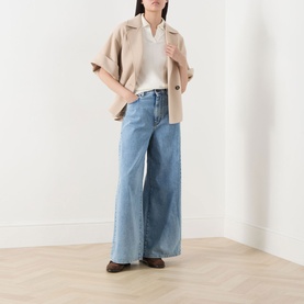 Model wearing Max Mara Weekend Neo Sand wool peacoat with wide-leg light blue jeans and dark brown loafers