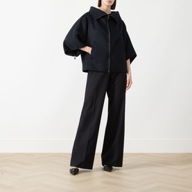 Model wearing Max Mara Main ultramarine cashmere coat with zip front and wide sleeves, styled with wide-leg black trousers and black heels