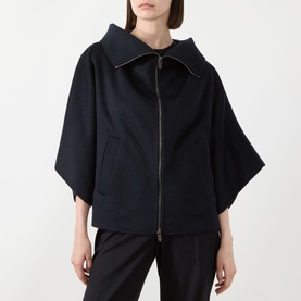 Model wearing Max Mara Main ultramarine cashmere coat with wide sleeves, high zip collar and front pockets, styled with black trousers