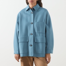 Model wearing Max Mara Weekend light blue wool jacket coat with front patch pockets and button fastening, styled with tan trousers