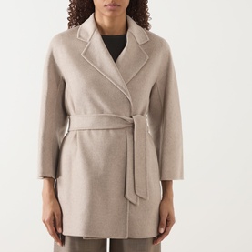 Model wearing Max Mara Main Detto Short Overlay Wrap Coat in sand cashmere, with self-tie belt, lapel collar and cropped sleeves