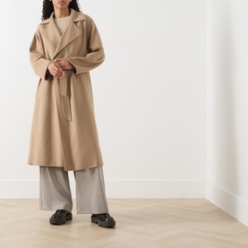 Model wearing Max Mara Weekend camel wool belted coat, styled with grey wide-leg trousers and black chunky loafers