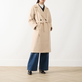 Model wearing Max Mara Weekend sand wool coat with tie belt, styled with wide-leg blue jeans and black heeled boots.