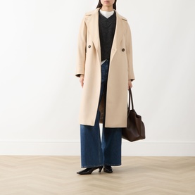 Model wearing Max Mara Weekend sand virgin wool coat, styled with dark knit, wide-leg jeans, black heels, and brown tote bag.