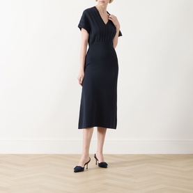 Model wearing Max Mara Main ultramarine midi dress with V-neck, short sleeves and fitted waist, styled with navy slingback heels
