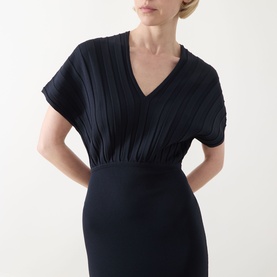 Model wearing Max Mara Main ultramarine dress with pleated V-neck bodice, elasticated waist, and short sleeves in a fitted silhouette.