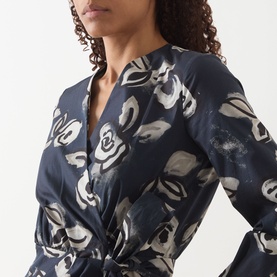 Model wearing Max Mara Main ultramarine floral-print cotton dress with wrap front, long sleeves, and gathered waist detail