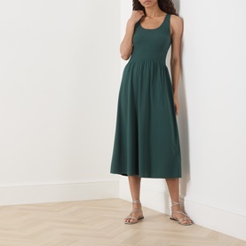 Model wearing Max Mara Weekend Calibri Flared Dress in green, sleeveless midi length with ribbed upper and flared skirt, styled with gold strappy