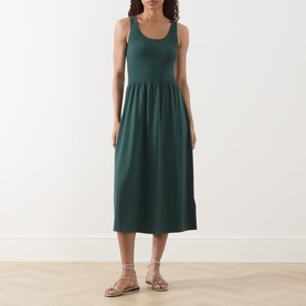 Model wearing Max Mara Weekend Calibri Flared Dress in green, sleeveless midi with ribbed upper and flared skirt, styled with gold sandals