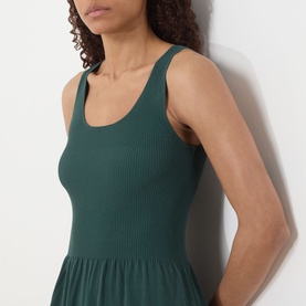Model wearing Max Mara Weekend Calibri Flared Dress in green, showing ribbed sleeveless bodice with scoop neckline, close-up crop view