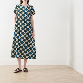 Model wearing Max Mara Weekend Vinci Printed Dress in dark green geometric print, midi length A-line silhouette, short sleeves, styled with brown