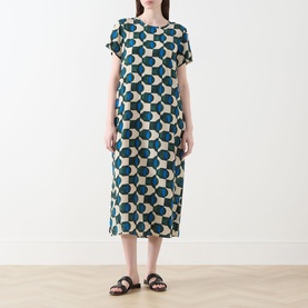 Model wearing Max Mara Weekend Vinci Printed Dress in dark green geometric circle print, midi length, short sleeves, with brown flat sandals