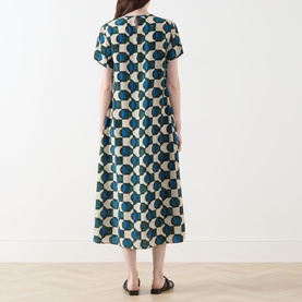 Model wearing Max Mara Weekend Vinci Printed Dress in dark green geometric print, midi length, short sleeves, A-line silhouette, back view