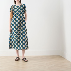 Model wearing Max Mara Weekend Vinci Printed Dress in dark green geometric print, midi length, short sleeves, A-line silhouette, styled with brown