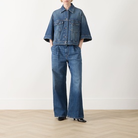 Model wearing Max Mara Weekend Liuti Denim Jacket in Navy Vintage with wide three-quarter sleeves, styled with matching wide-leg jeans and black