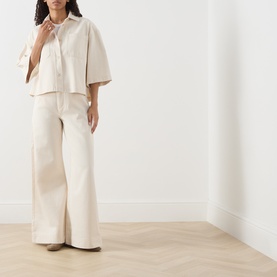 Model wearing Max Mara Weekend ecru cotton cropped jacket with wide-leg trousers in matching ecru tone.