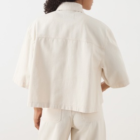 Model wearing Max Mara Weekend ecru cotton jacket, back view, with short sleeves and relaxed cropped fit, styled with matching ecru trousers.