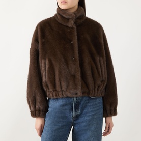 Model wearing Max Mara Weekend Anemone Faux Fur Jacket in brown, cropped length with stand collar and elasticated hem, styled with blue jeans.