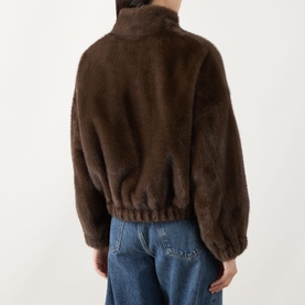Model wearing Max Mara Weekend Anemone Faux Fur Jacket in brown, back view, showing elasticated hem and fluffy texture, styled with blue jeans
